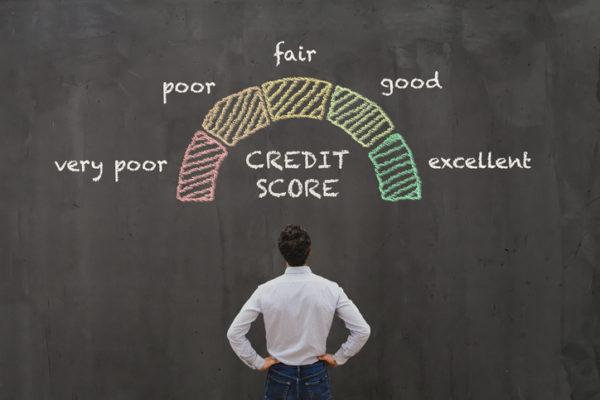 man looking at chalk illustration of credit score